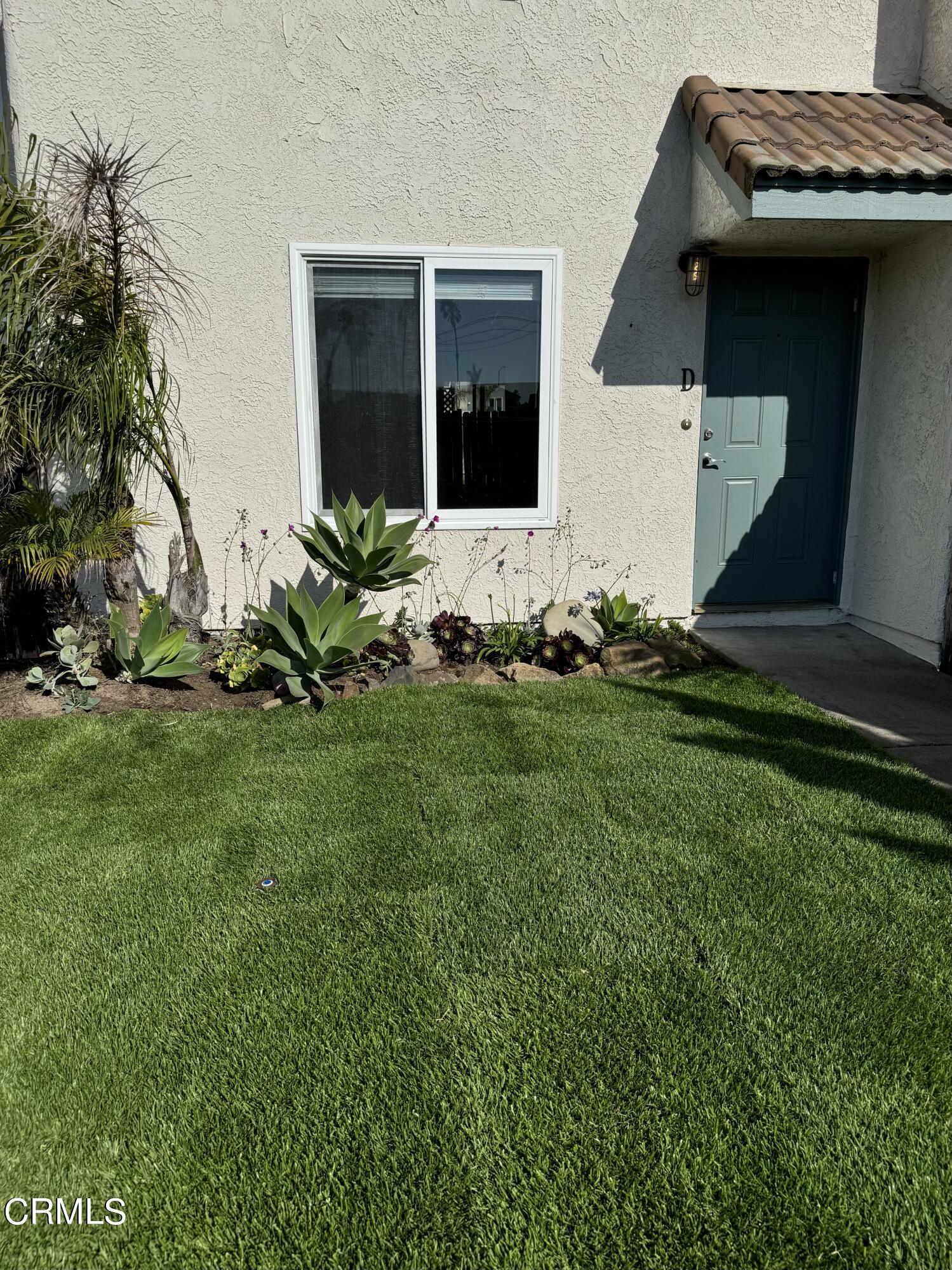 1031 Dunes Street, Unit D Oxnard, CA 93035 - Photo 13 of 26 a house with garden in front of it
