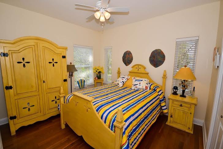53 Maple Street Santa Rosa Beach, FL 32459 - Photo 11 of 14 a bedroom with a bed and wooden floor