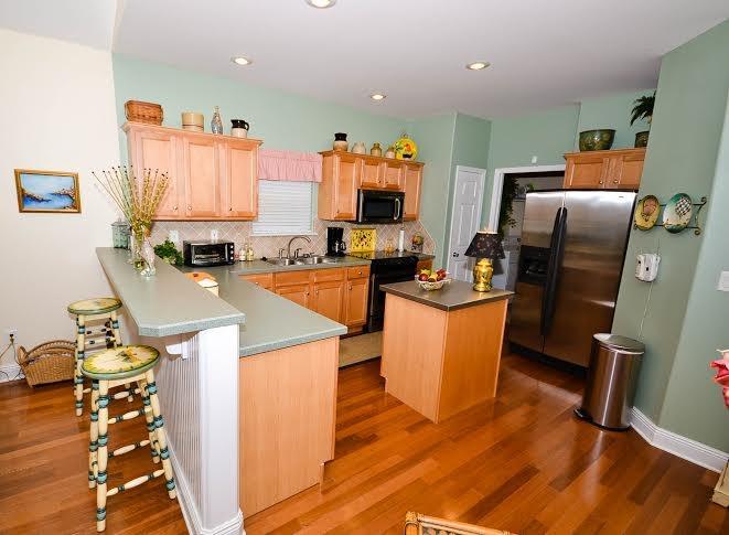 53 Maple Street Santa Rosa Beach, FL 32459 - Photo 5 of 14 a kitchen that has a lot of cabinets and refrigerator