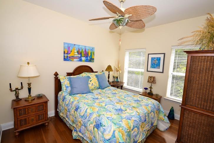 53 Maple Street Santa Rosa Beach, FL 32459 - Photo 9 of 14 a bedroom with a bed and wooden floor