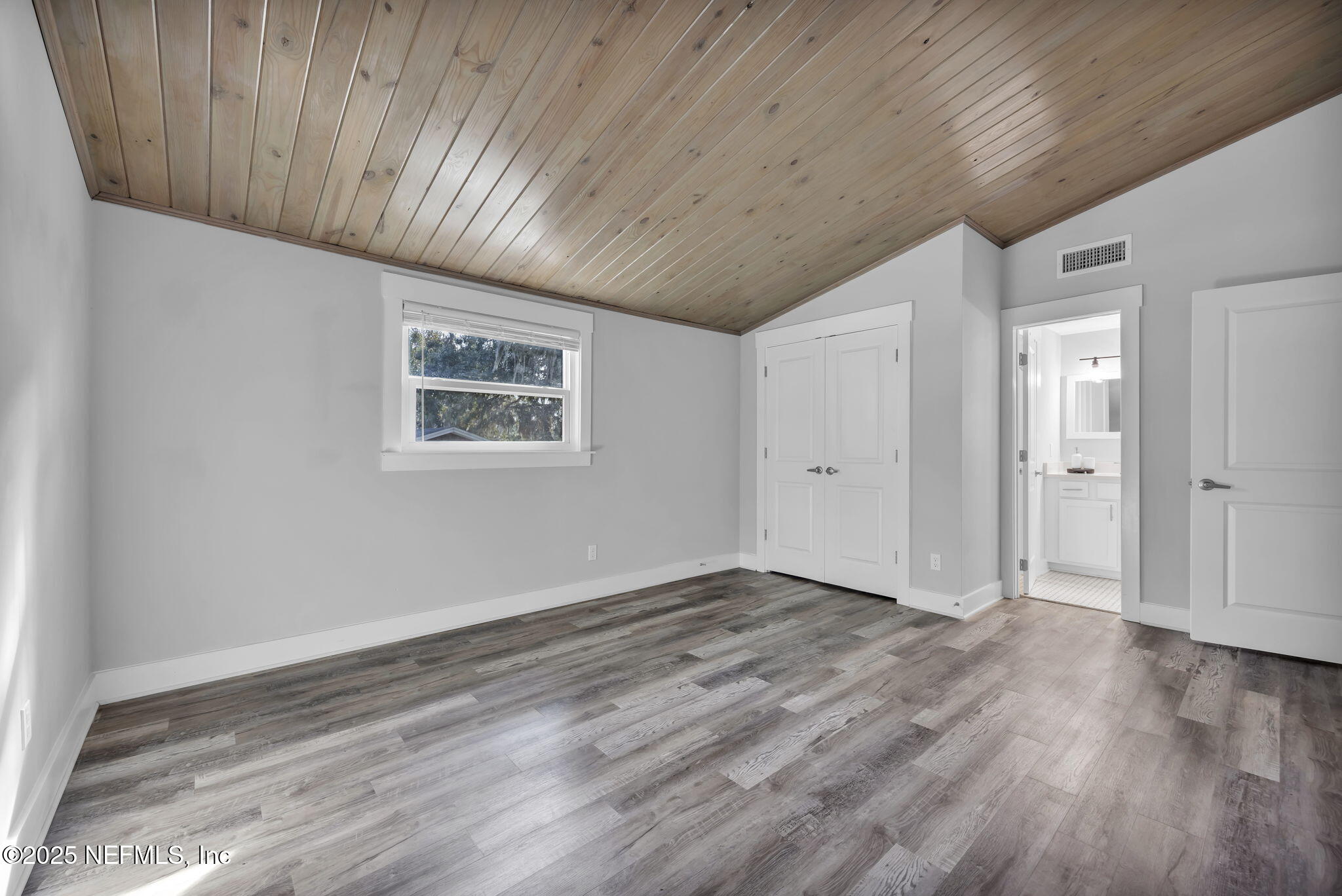431 19th Street North Jacksonville Beach, FL 32250 - Photo 32 of 53 a view of an empty room with wooden floor and a ceiling fan