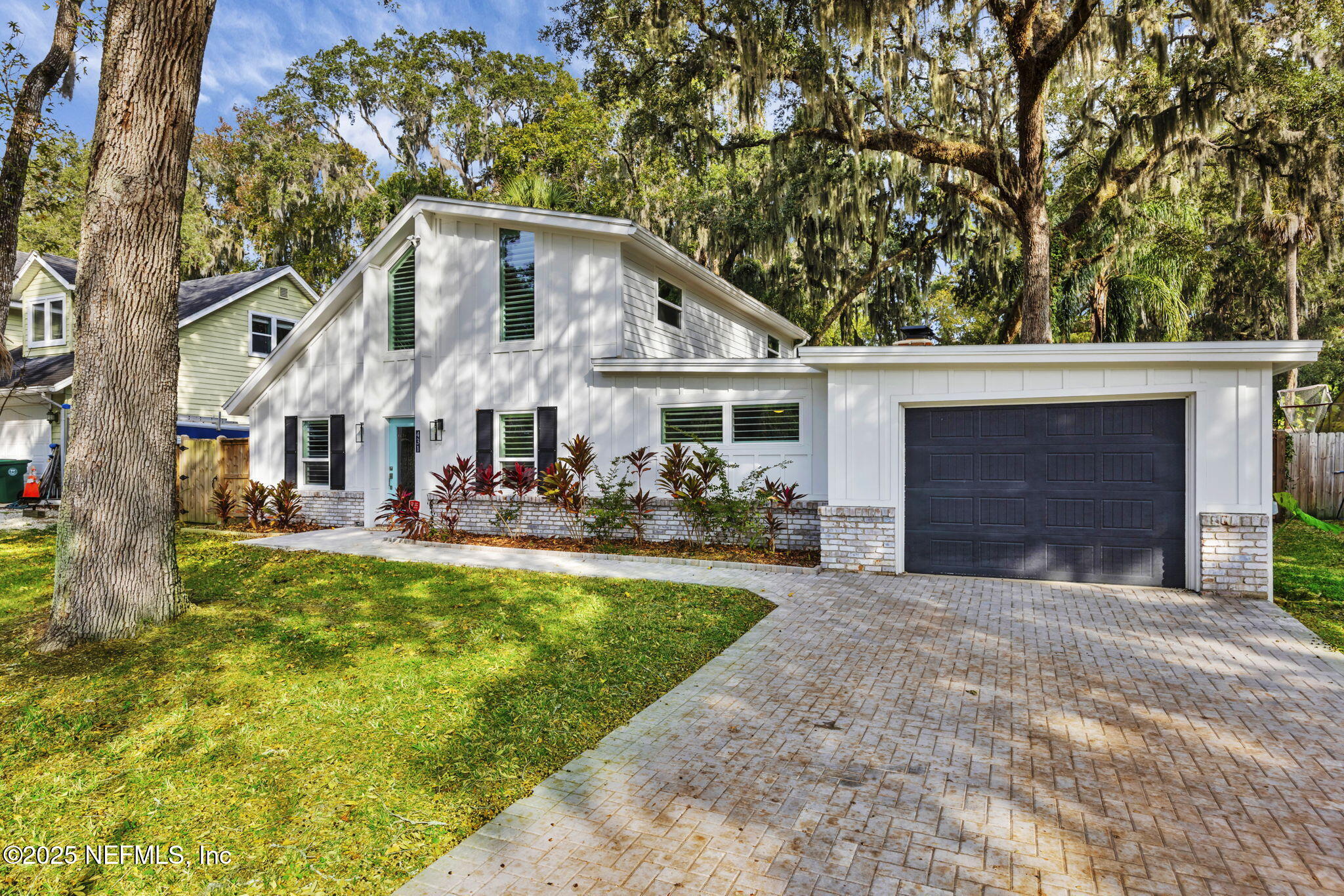 431 19th Street North Jacksonville Beach, FL 32250 - Photo 42 of 53 a view of a white house with a big yard and large trees