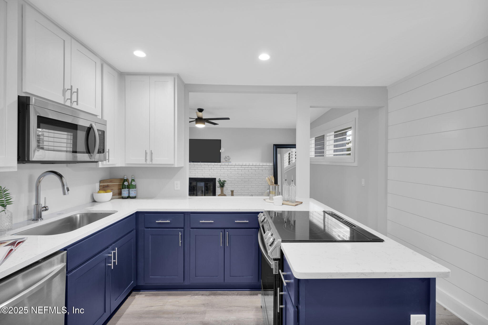 431 19th Street North Jacksonville Beach, FL 32250 - Photo 8 of 53 a kitchen with stainless steel appliances a sink a stove a microwave a center island and cabinets