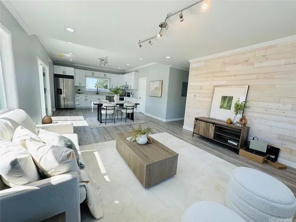 a living room with furniture and wooden floor