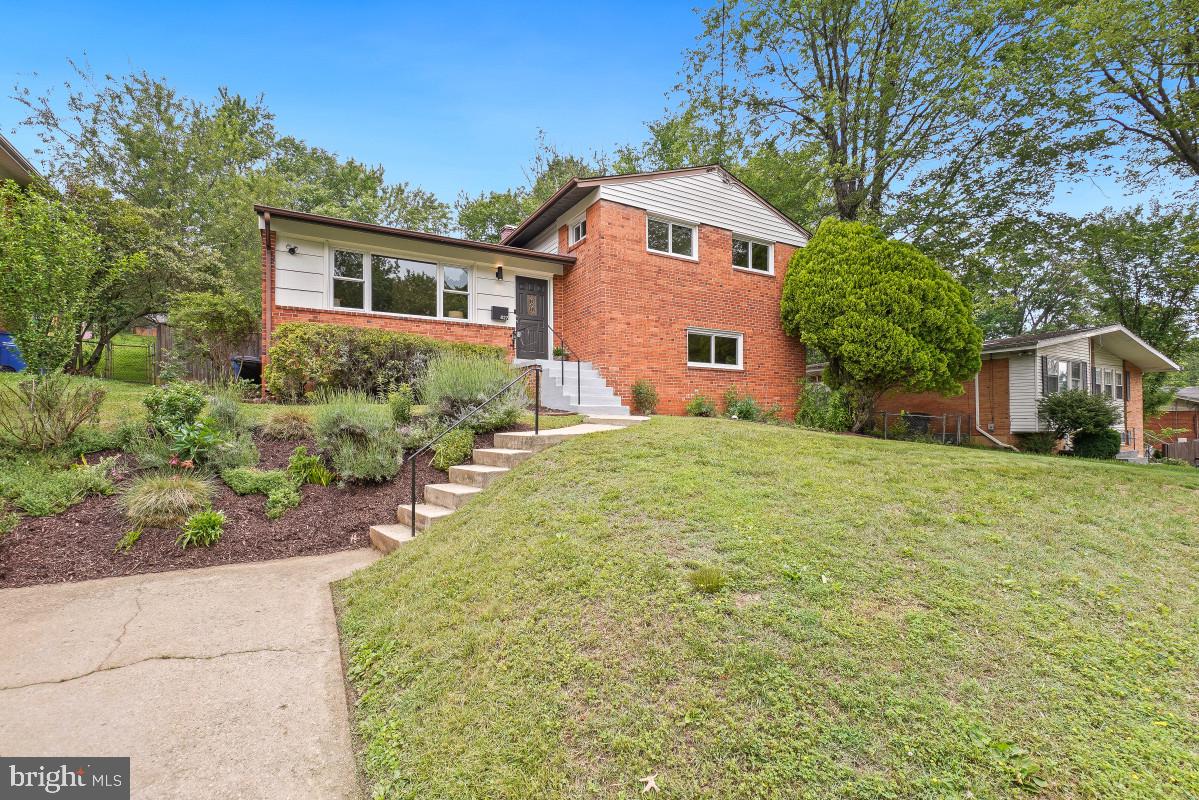 827 Caddington Avenue Silver Spring, MD 20901 - Photo 2 of 45 a front view of a house with a garden