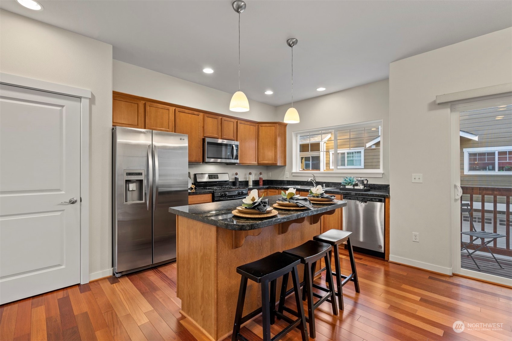 2026 112th Street Southwest Everett, WA 98204 - Photo 12 of 33 a kitchen with stainless steel appliances a stove a refrigerator a sink a dining table and chairs
