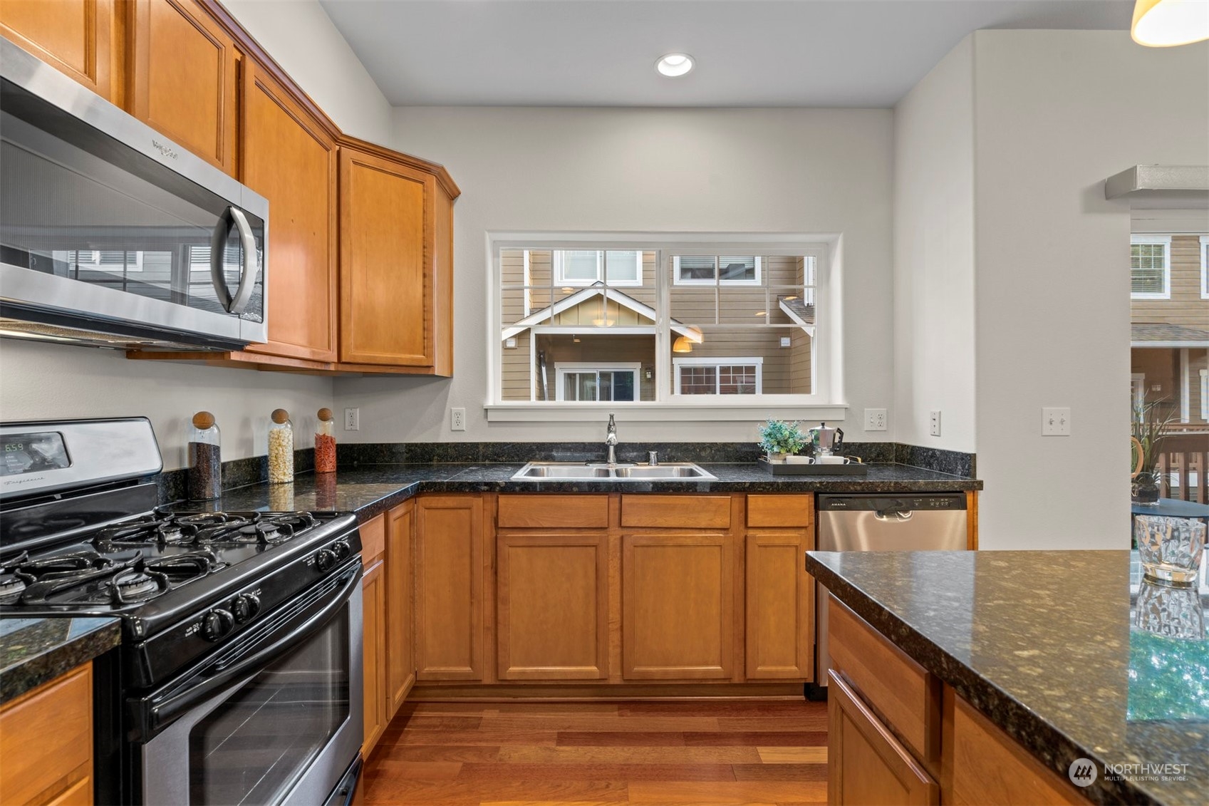 2026 112th Street Southwest Everett, WA 98204 - Photo 14 of 33 a kitchen with granite countertop a stove and a sink