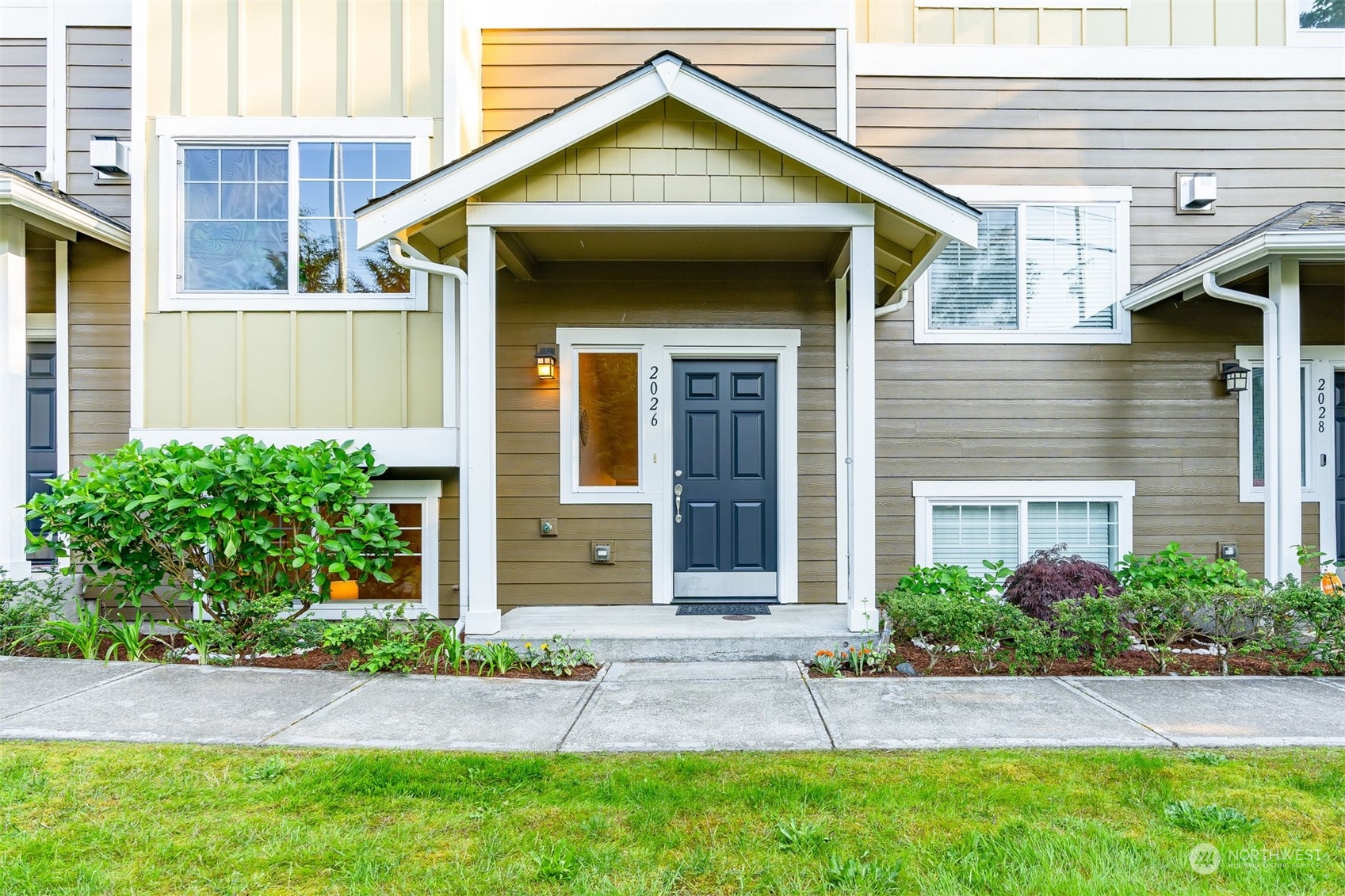 2026 112th Street Southwest Everett, WA 98204 - Photo 2 of 33 a view of a house with small yard plants and large tree