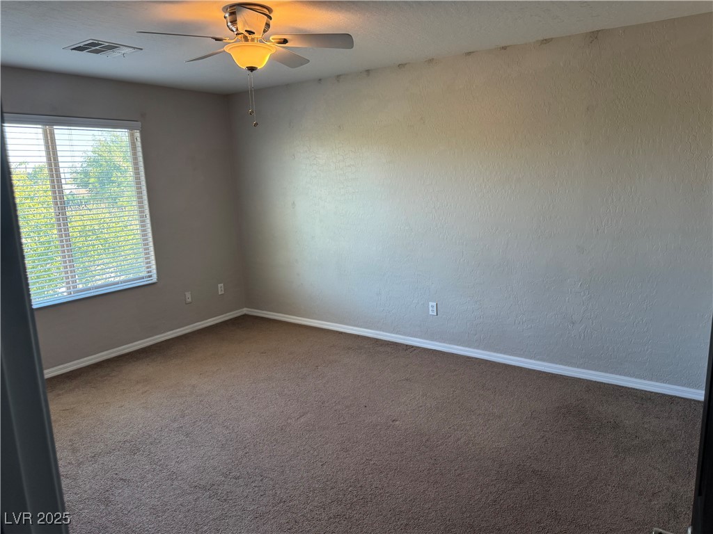 5522 Porcupine Rim Street Las Vegas, NV 89130 - Photo 15 of 28 Carpeted spare room with baseboards and ceiling fan
