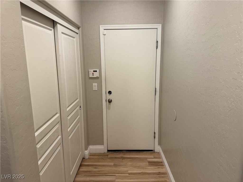 5522 Porcupine Rim Street Las Vegas, NV 89130 - Photo 21 of 28 Doorway to outside featuring a textured wall and wood finished floors