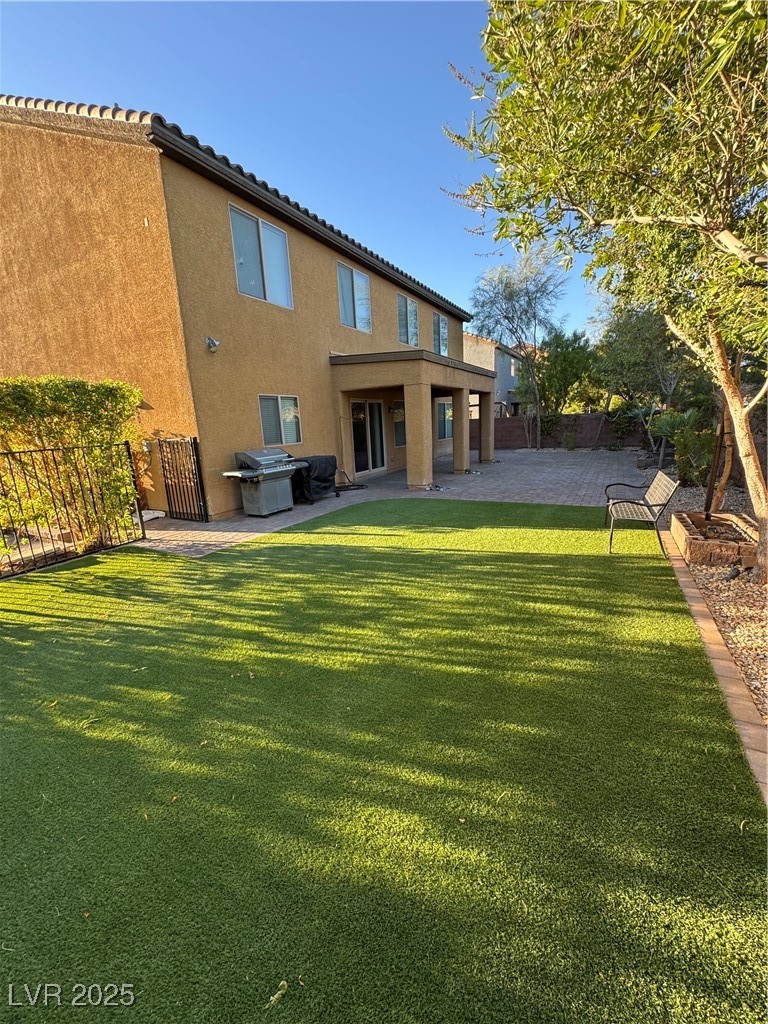 5522 Porcupine Rim Street Las Vegas, NV 89130 - Photo 25 of 28 Back of house featuring a fenced backyard, stucco siding, and a patio