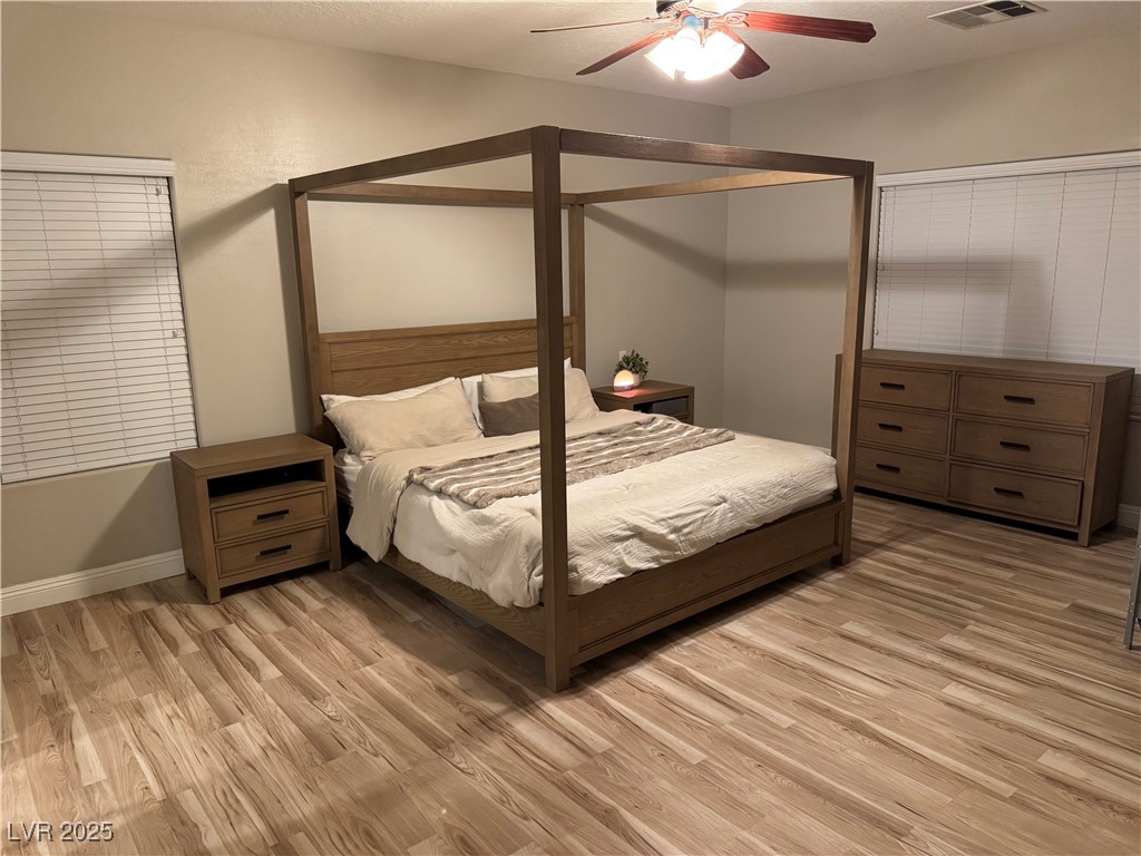 5522 Porcupine Rim Street Las Vegas, NV 89130 - Photo 8 of 28 Bedroom featuring light wood-type flooring, ceiling fan, and a textured ceiling