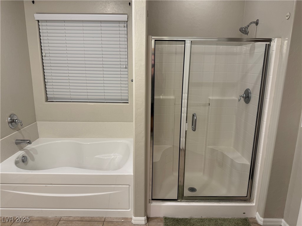 5522 Porcupine Rim Street Las Vegas, NV 89130 - Photo 9 of 28 Full bathroom with a shower stall, a bath, and tile patterned floors