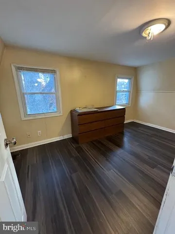 a room with wooden floor and window