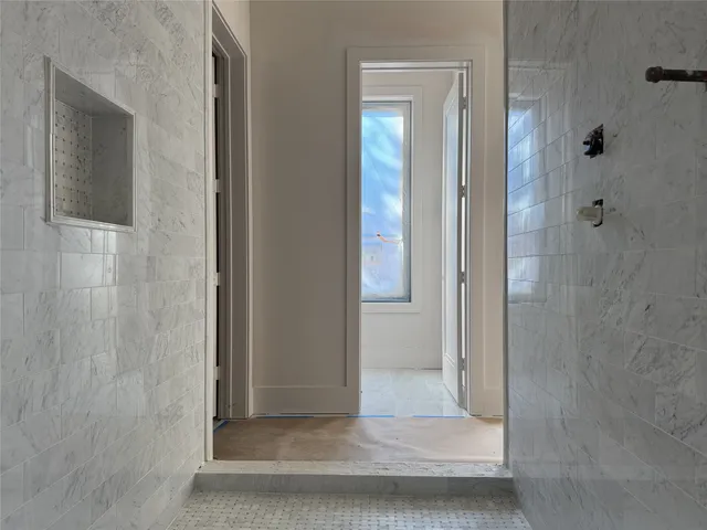 a view of a bathroom that has a glass shower door