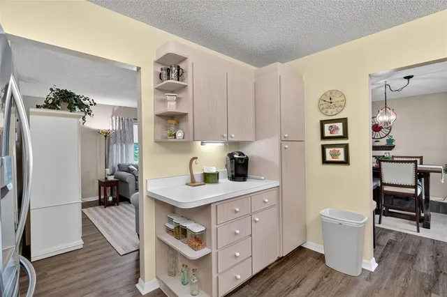a kitchen with a sink cabinets and wooden floor