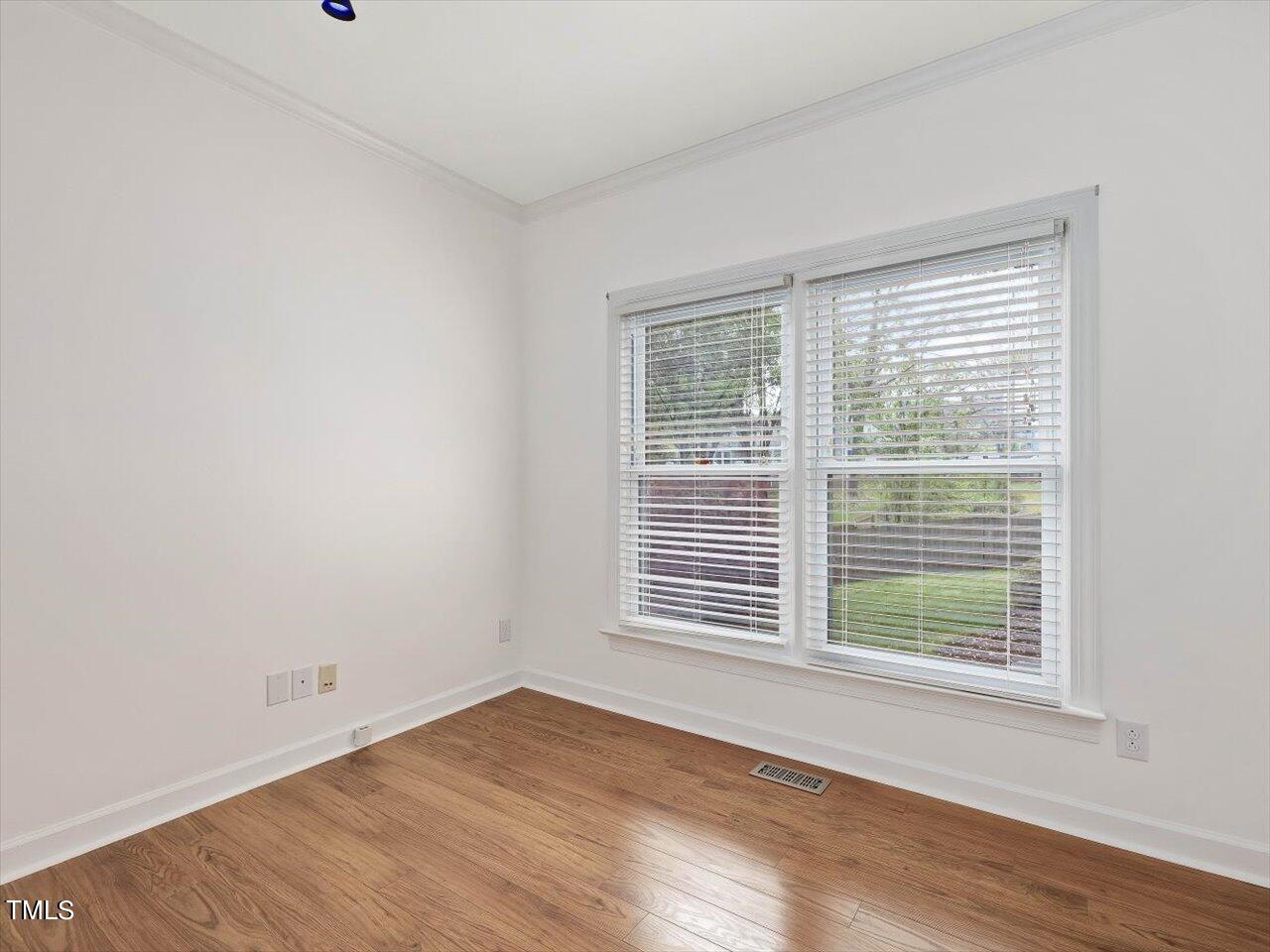 7001 Three Bridges Circle Raleigh, NC 27613 - Photo 15 of 25 a view of an empty room with wooden floor and a window