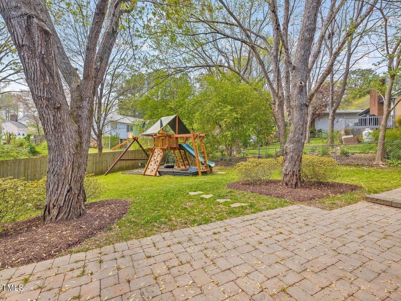 7001 Three Bridges Circle Raleigh, NC 27613 - Photo 24 of 25 a view of a garden with a tree