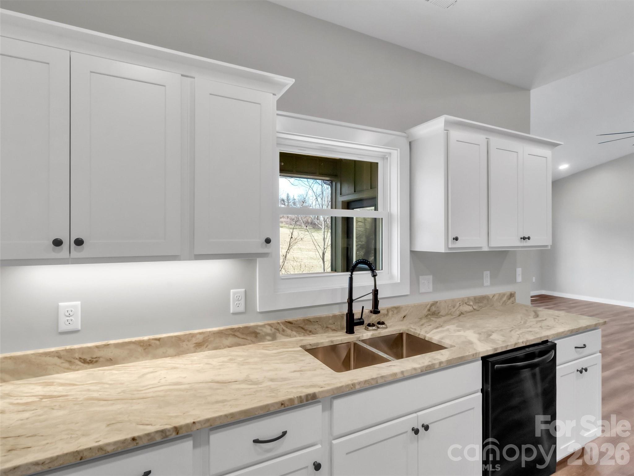 171 Peyton Elaine Road Clyde, NC 28721 - Photo 11 of 25 a kitchen with granite countertop white cabinets and a sink