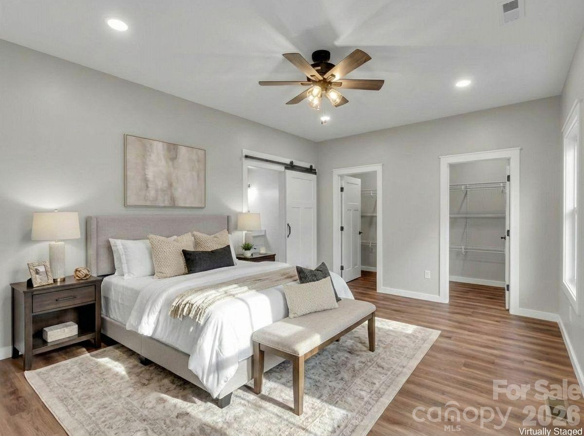 171 Peyton Elaine Road Clyde, NC 28721 - Photo 14 of 25 a spacious bedroom with a bed and a mirror