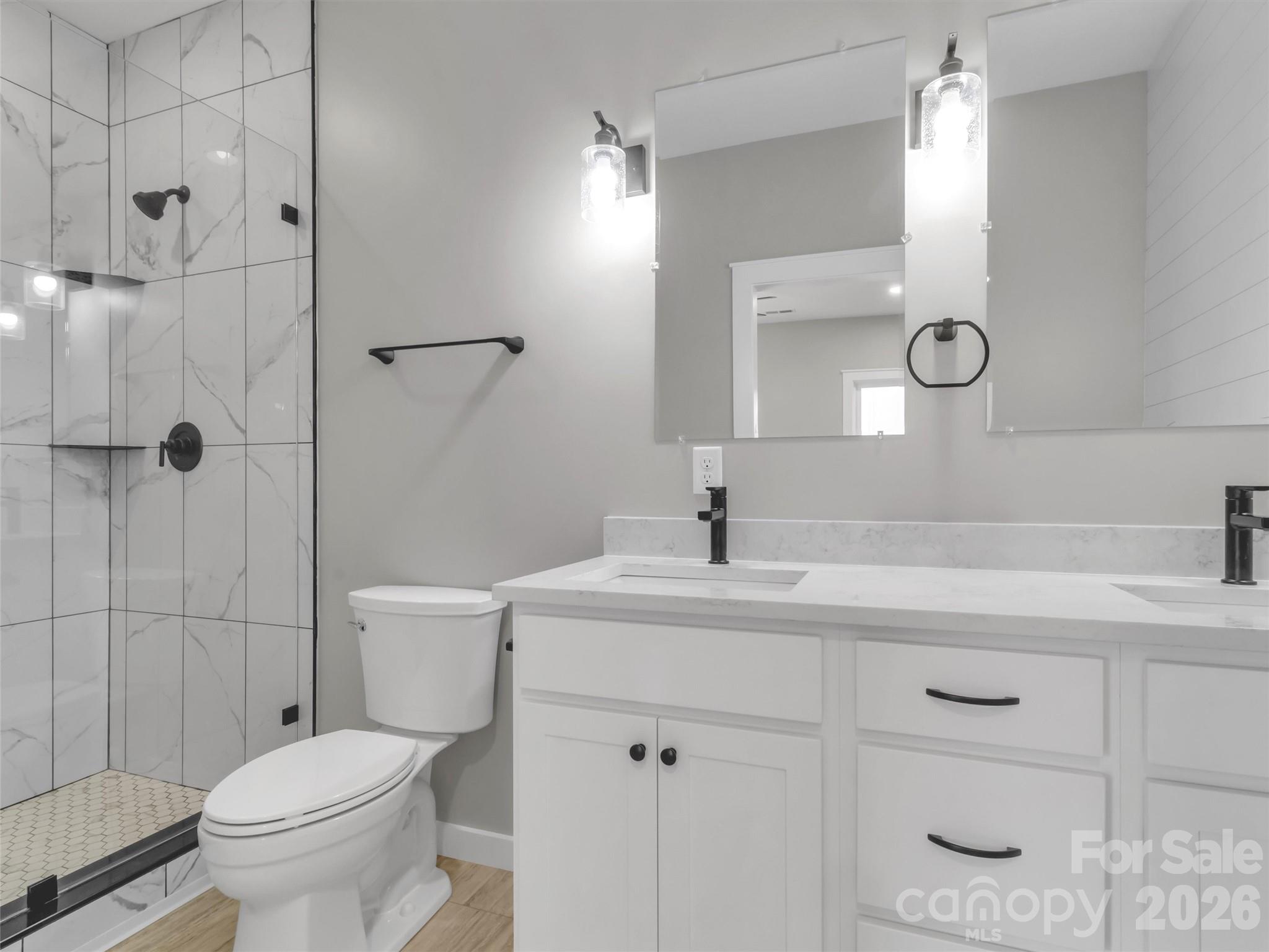 171 Peyton Elaine Road Clyde, NC 28721 - Photo 15 of 25 a bathroom with a sink toilet vanity and shower