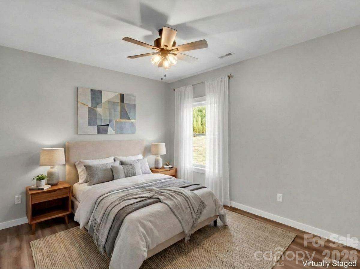 171 Peyton Elaine Road Clyde, NC 28721 - Photo 17 of 25 a bedroom with a bed and a chandelier