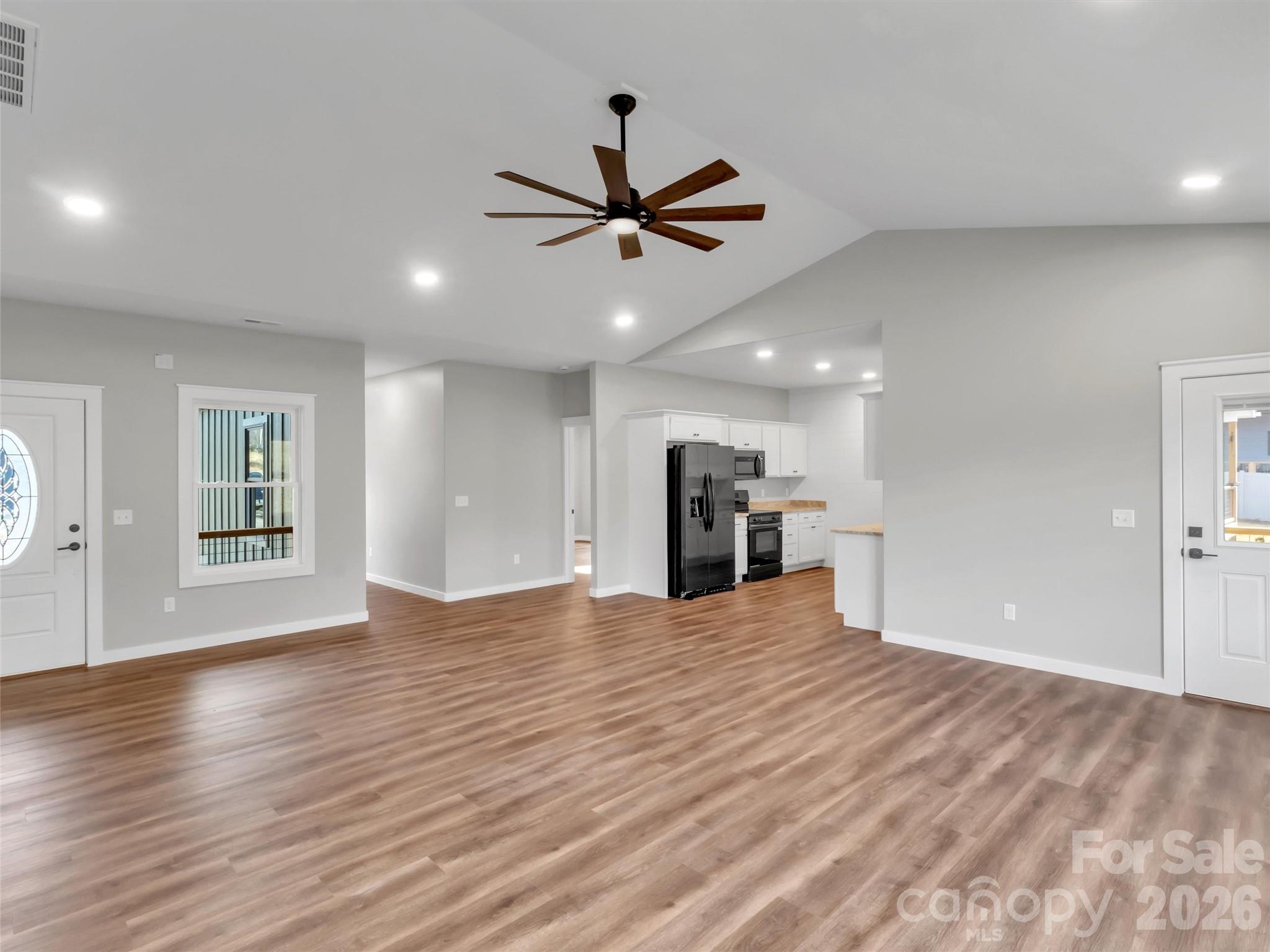 171 Peyton Elaine Road Clyde, NC 28721 - Photo 6 of 25 a view of an empty room with window and wooden floor