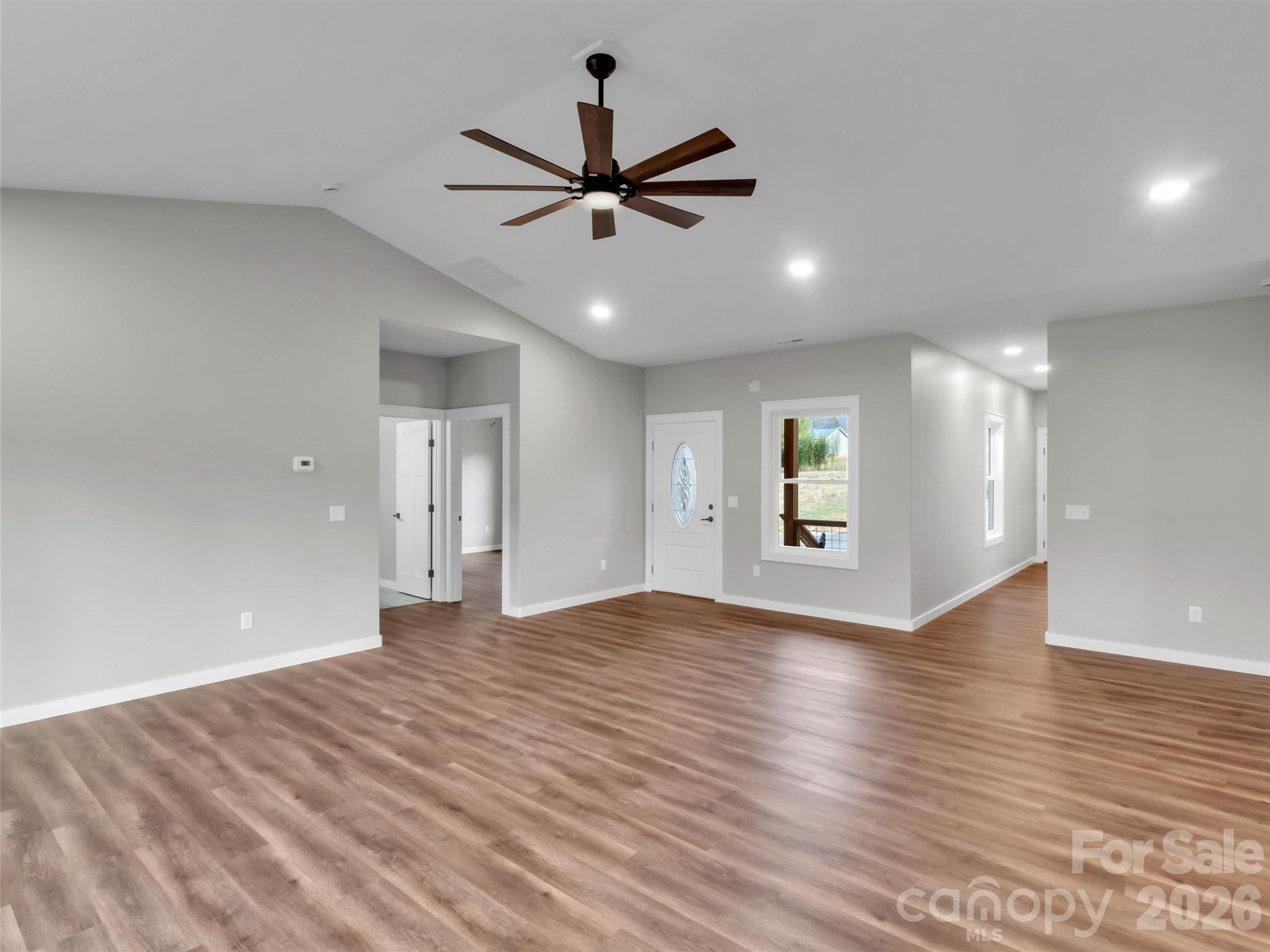 171 Peyton Elaine Road Clyde, NC 28721 - Photo 7 of 25 a view of an empty room with wooden floor and a ceiling fan