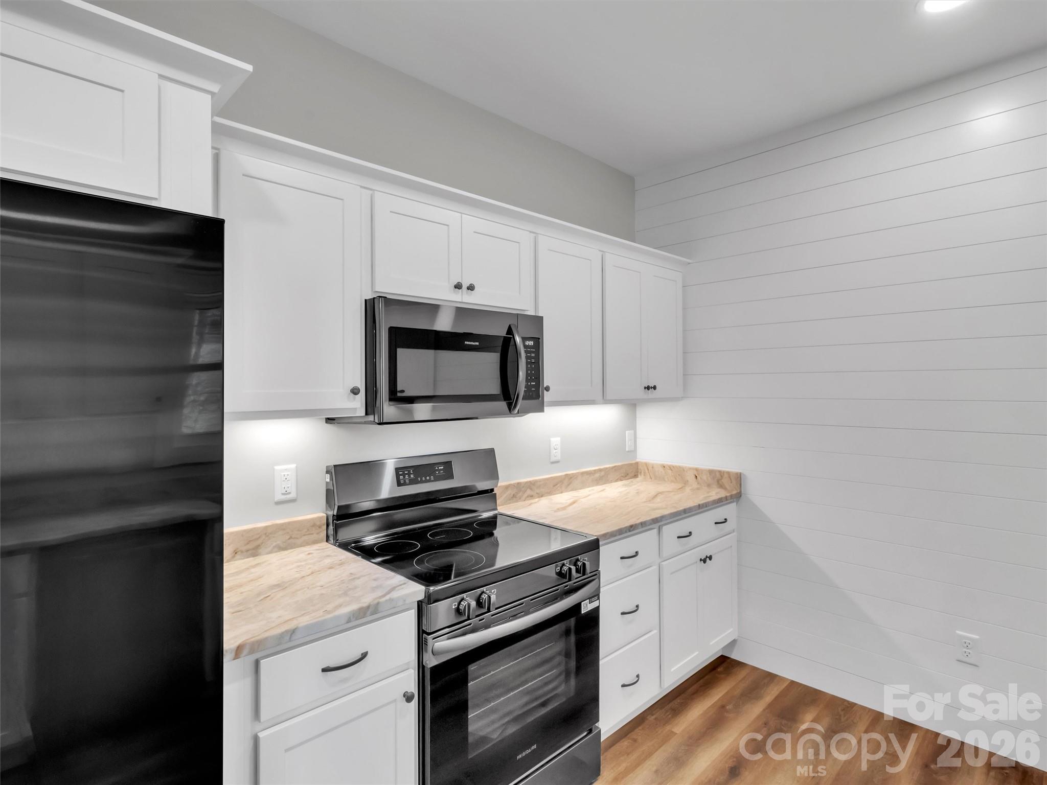 171 Peyton Elaine Road Clyde, NC 28721 - Photo 10 of 25 a kitchen with white cabinets stainless steel appliances and sink