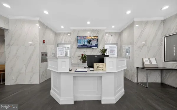 a view of kitchen with kitchen island stainless steel appliances refrigerator sink and cabinets