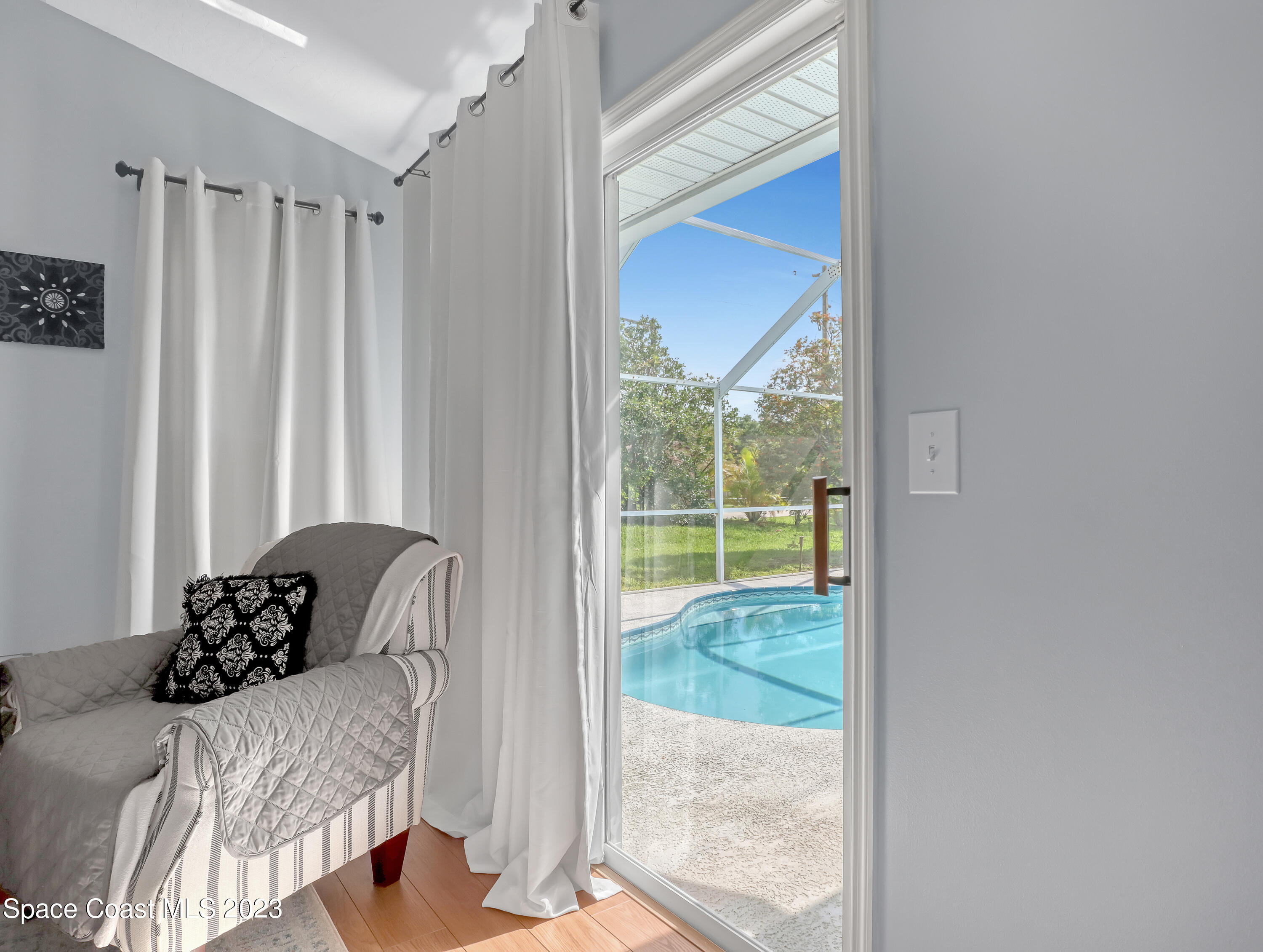 1025 Oak Tree Place Malabar, FL 32950 - Photo 12 of 33 a bed sitting in a bedroom next to a window