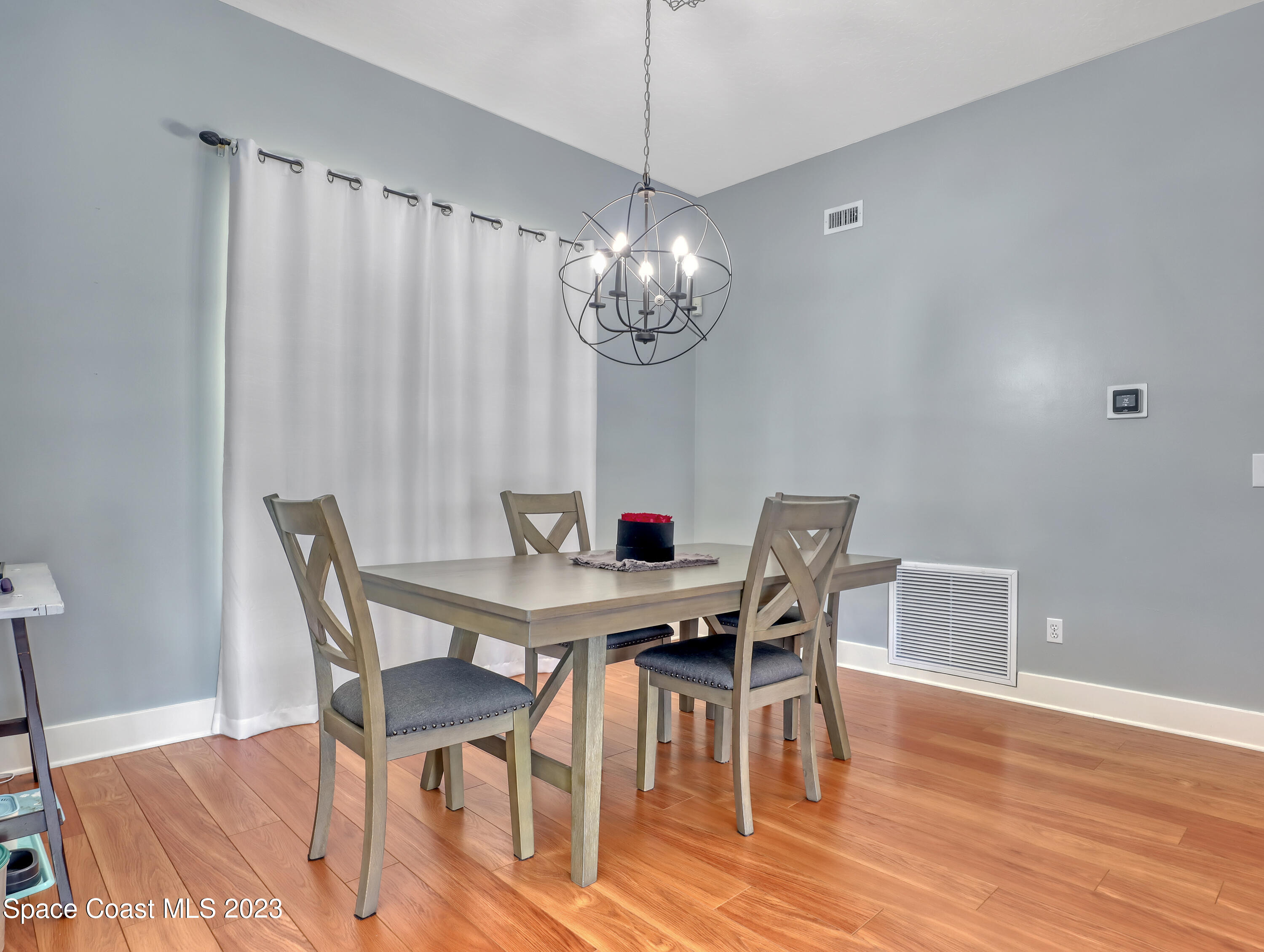 1025 Oak Tree Place Malabar, FL 32950 - Photo 17 of 33 a view of a dining room with furniture and wooden floor