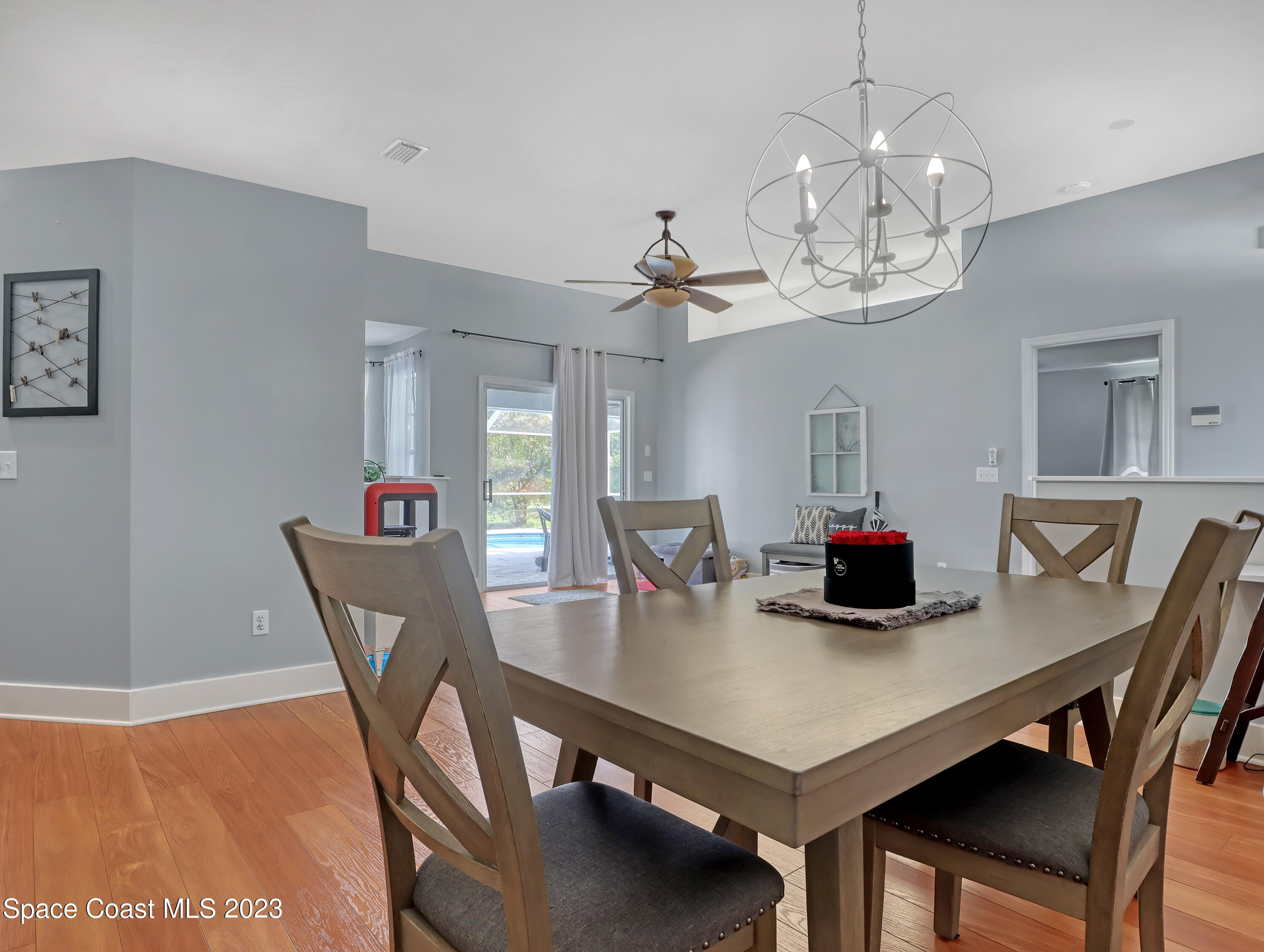 1025 Oak Tree Place Malabar, FL 32950 - Photo 18 of 33 a view of a dining room with furniture and chandelier