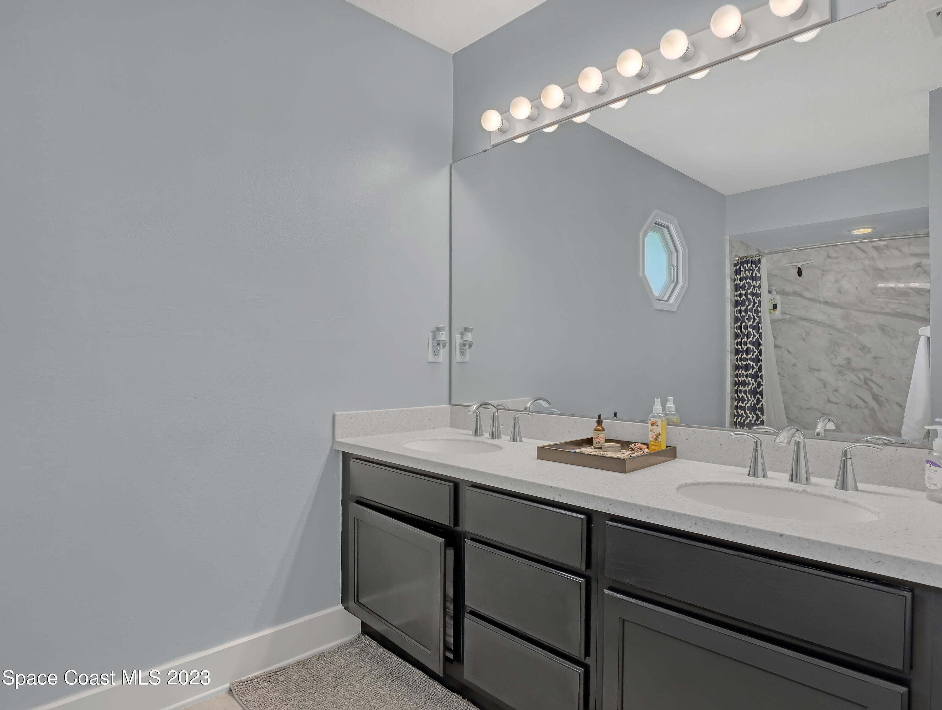 1025 Oak Tree Place Malabar, FL 32950 - Photo 22 of 33 a bathroom with a sink and a mirror