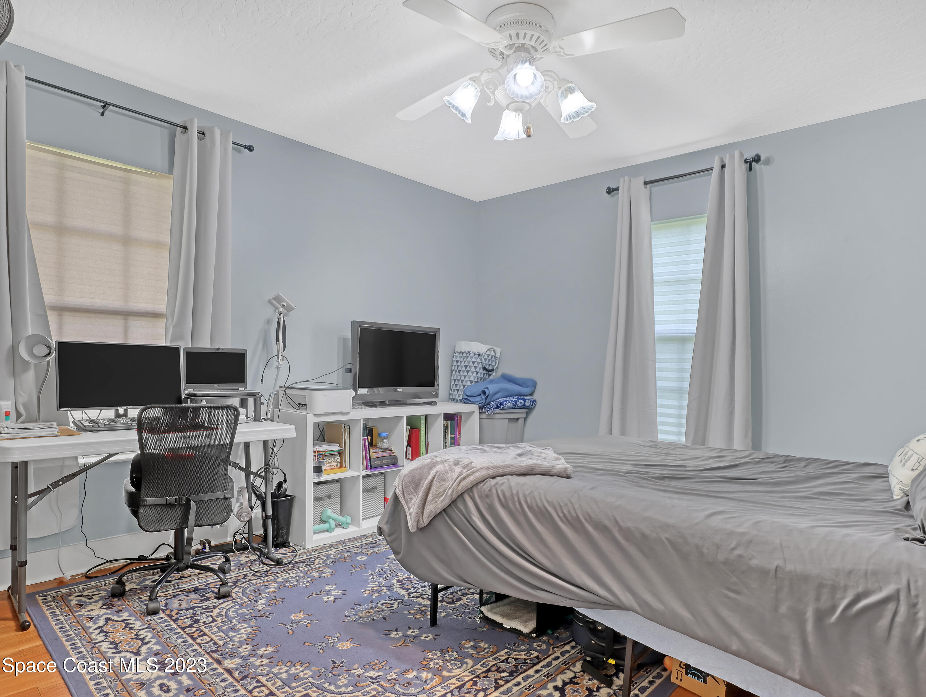 1025 Oak Tree Place Malabar, FL 32950 - Photo 24 of 33 a bedroom with a bed and a desk