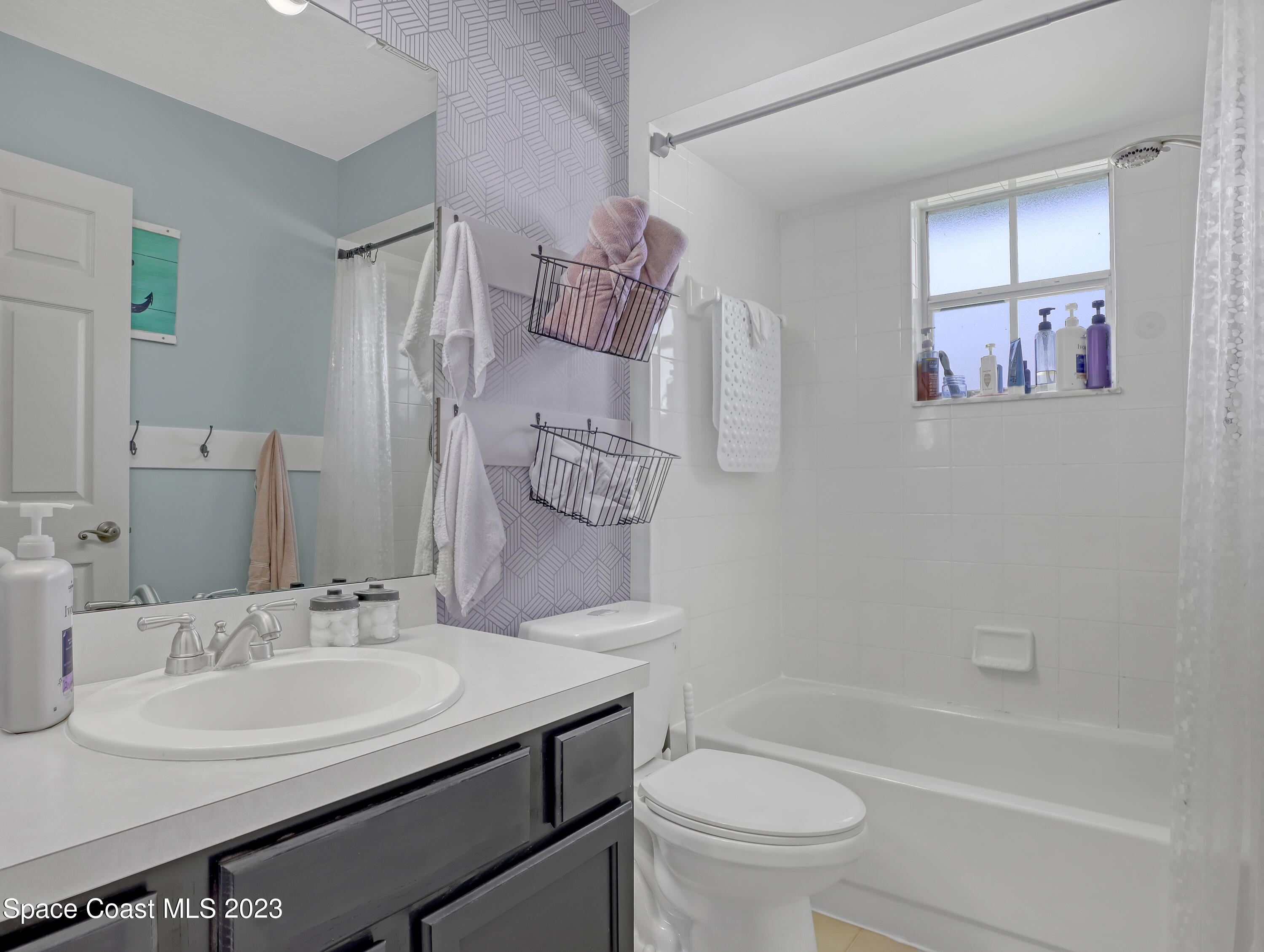 1025 Oak Tree Place Malabar, FL 32950 - Photo 26 of 33 a bathroom with a sink toilet tub and shower