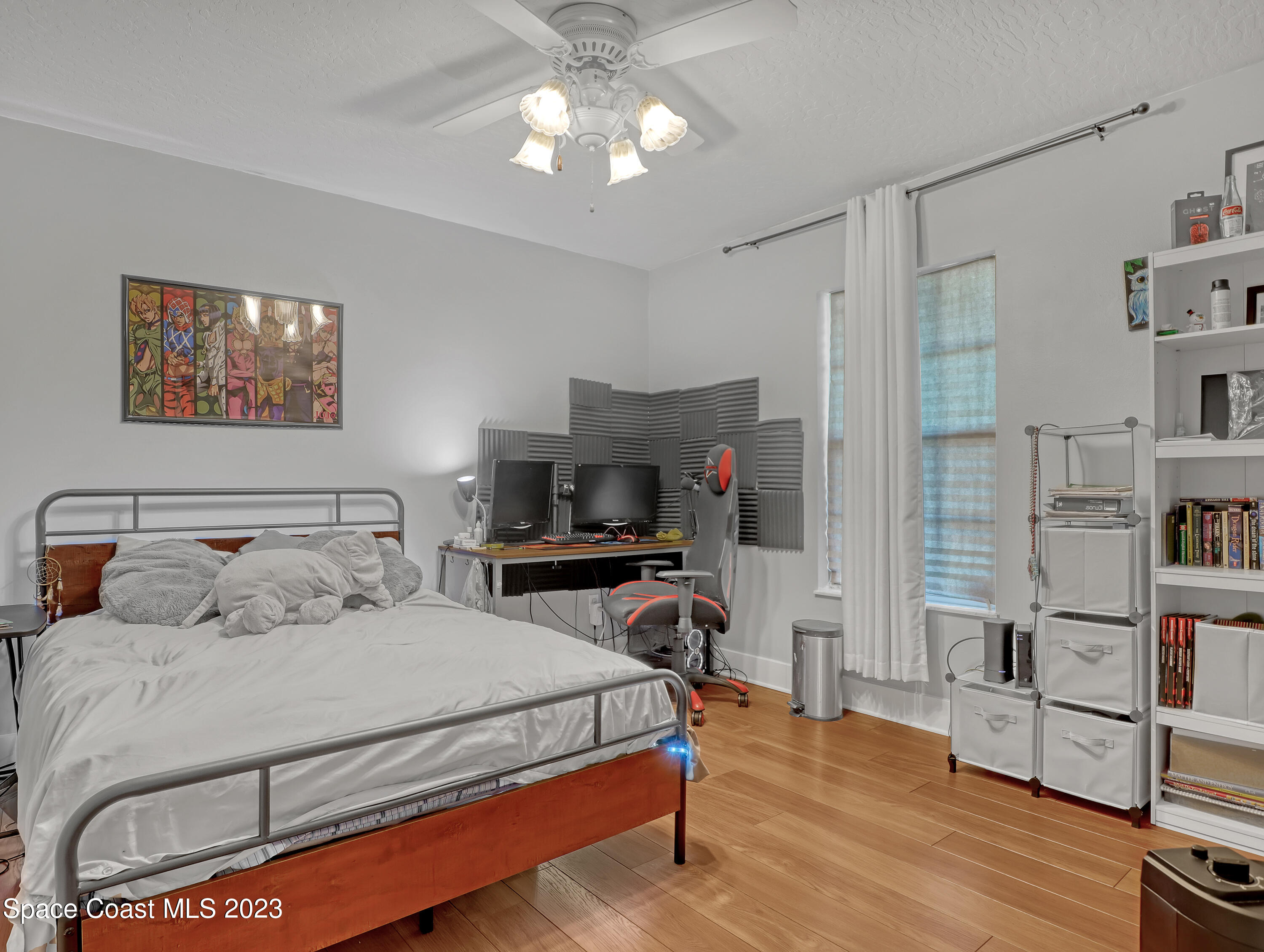 1025 Oak Tree Place Malabar, FL 32950 - Photo 27 of 33 a bedroom with a bed furniture and a flat tv screen on the dresser