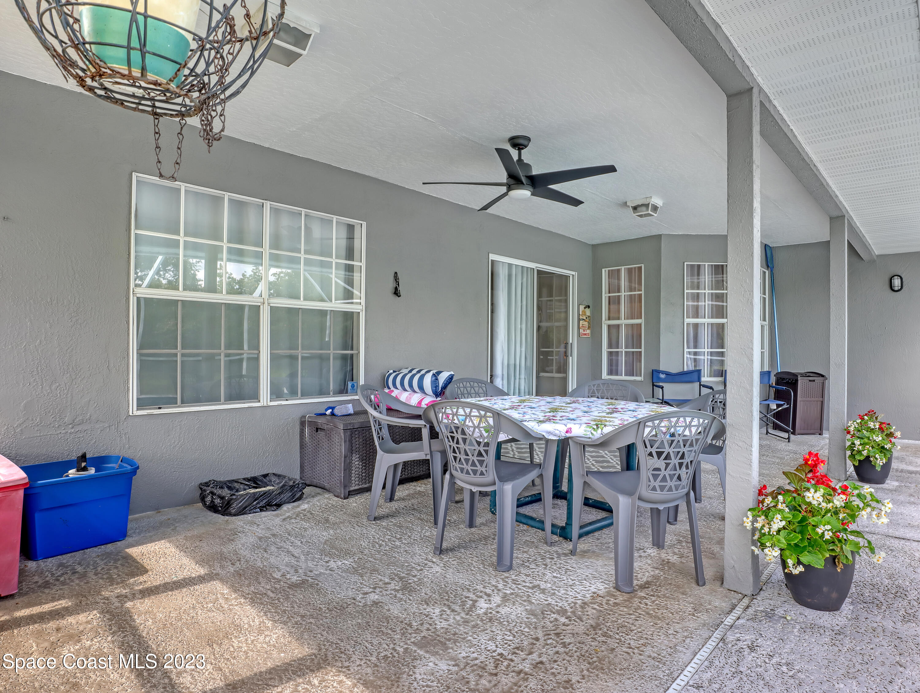 1025 Oak Tree Place Malabar, FL 32950 - Photo 29 of 33 a dining room with wooden floor a chandelier a wooden table and chairs