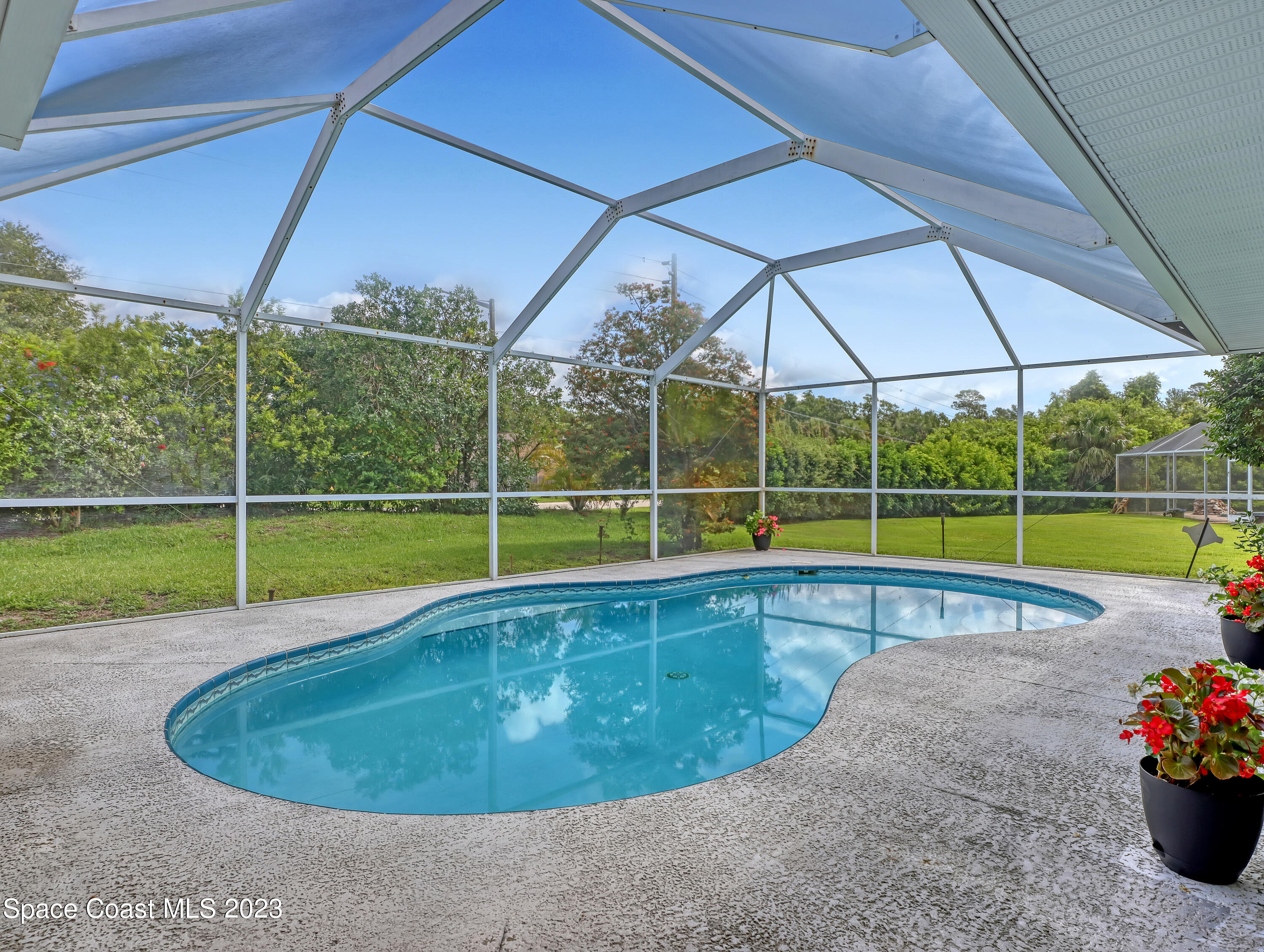 1025 Oak Tree Place Malabar, FL 32950 - Photo 30 of 33 a view of a backyard with a swimming pool