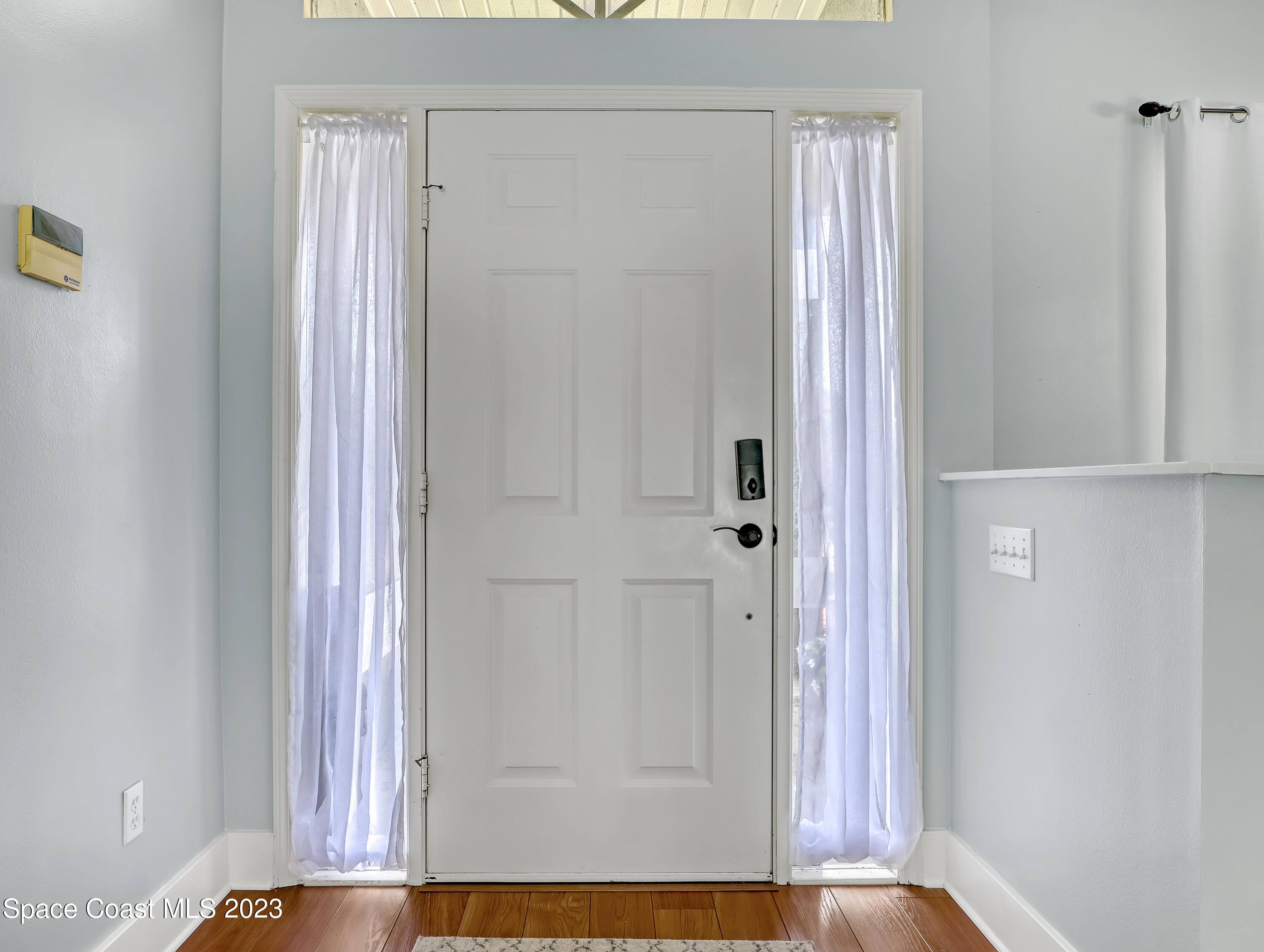 1025 Oak Tree Place Malabar, FL 32950 - Photo 4 of 33 a view of front door with hallway