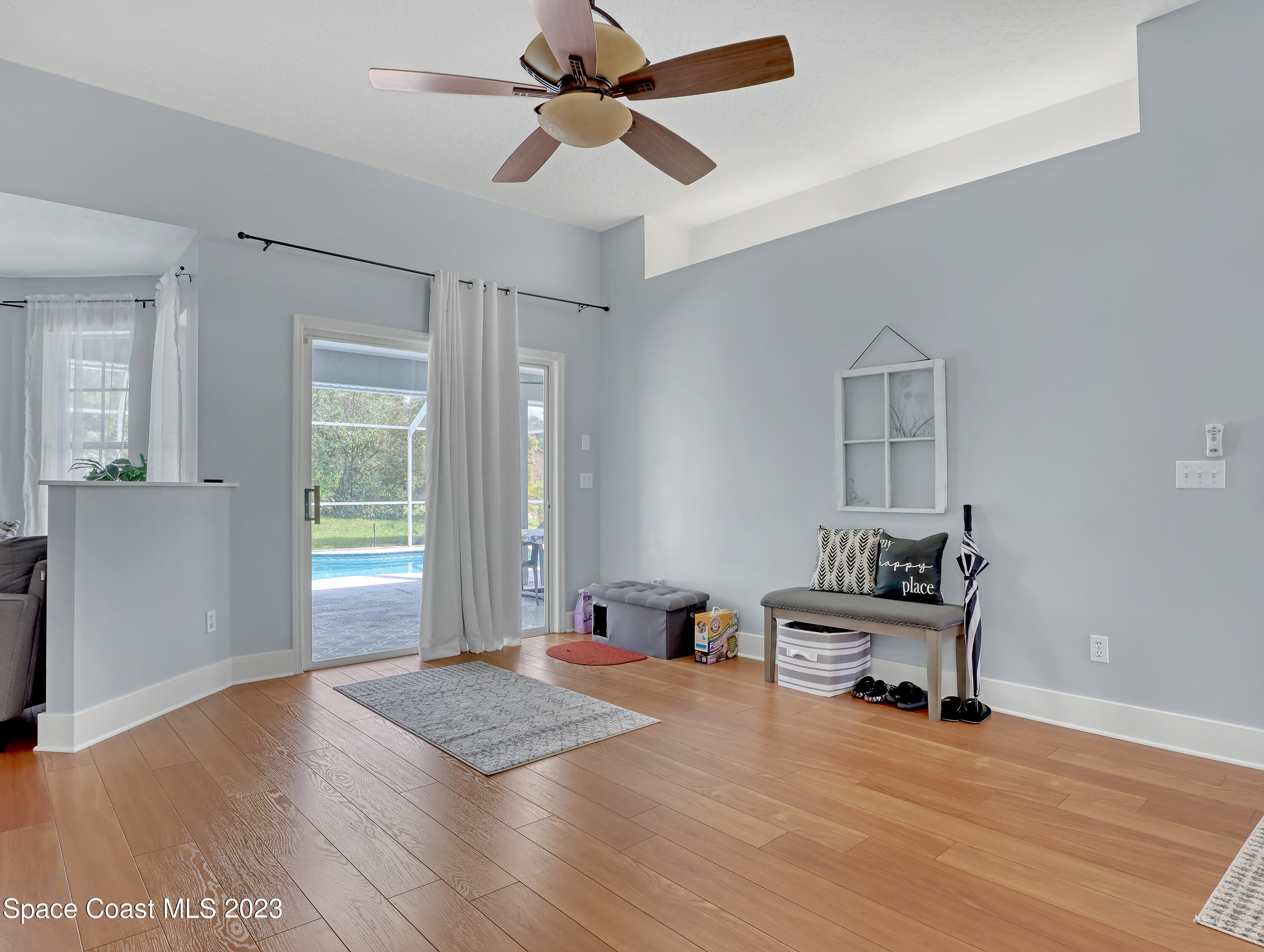 1025 Oak Tree Place Malabar, FL 32950 - Photo 7 of 33 a view of a room with wooden floor and windows