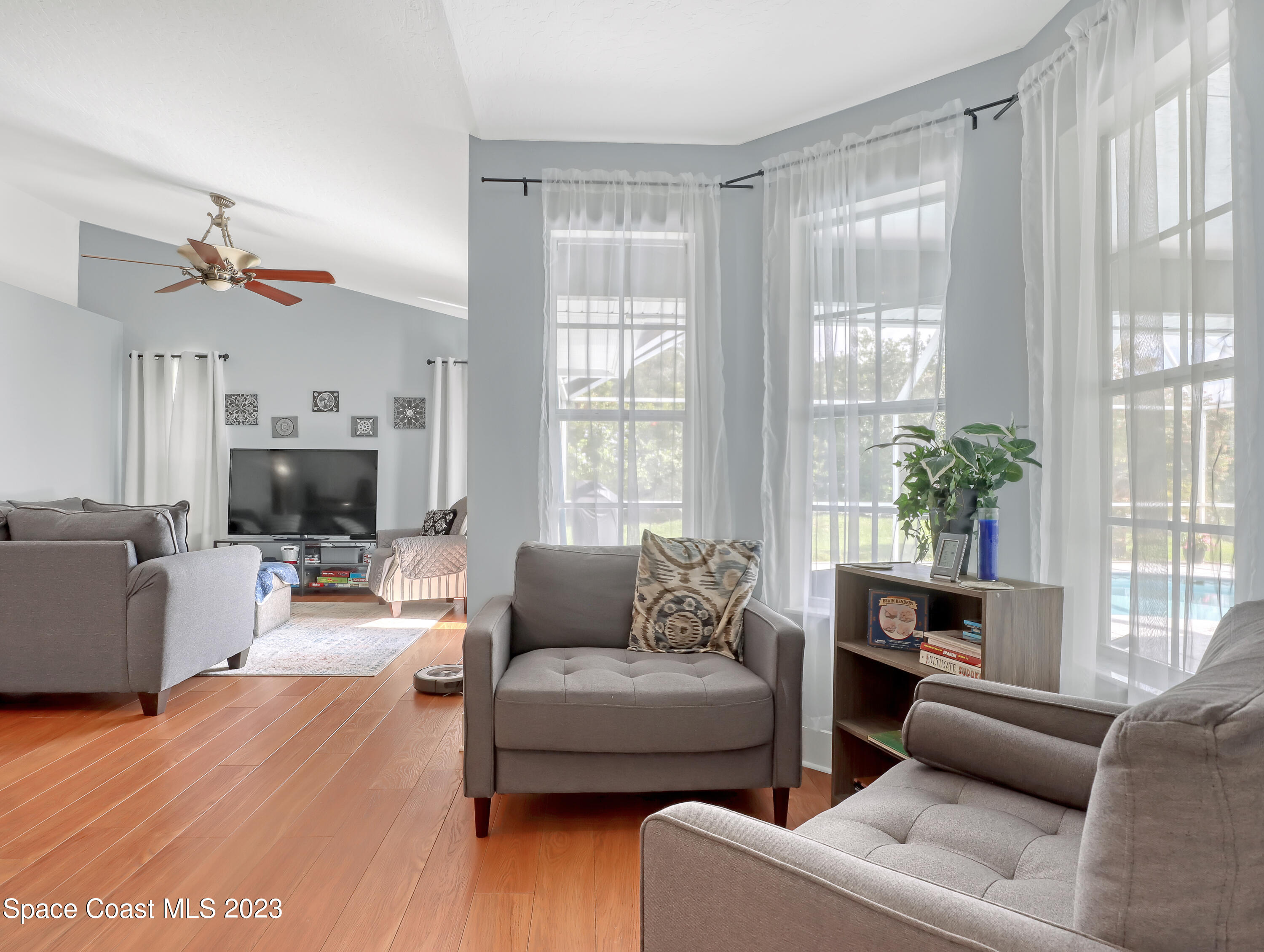 1025 Oak Tree Place Malabar, FL 32950 - Photo 8 of 33 a living room with furniture a fireplace and a flat screen tv