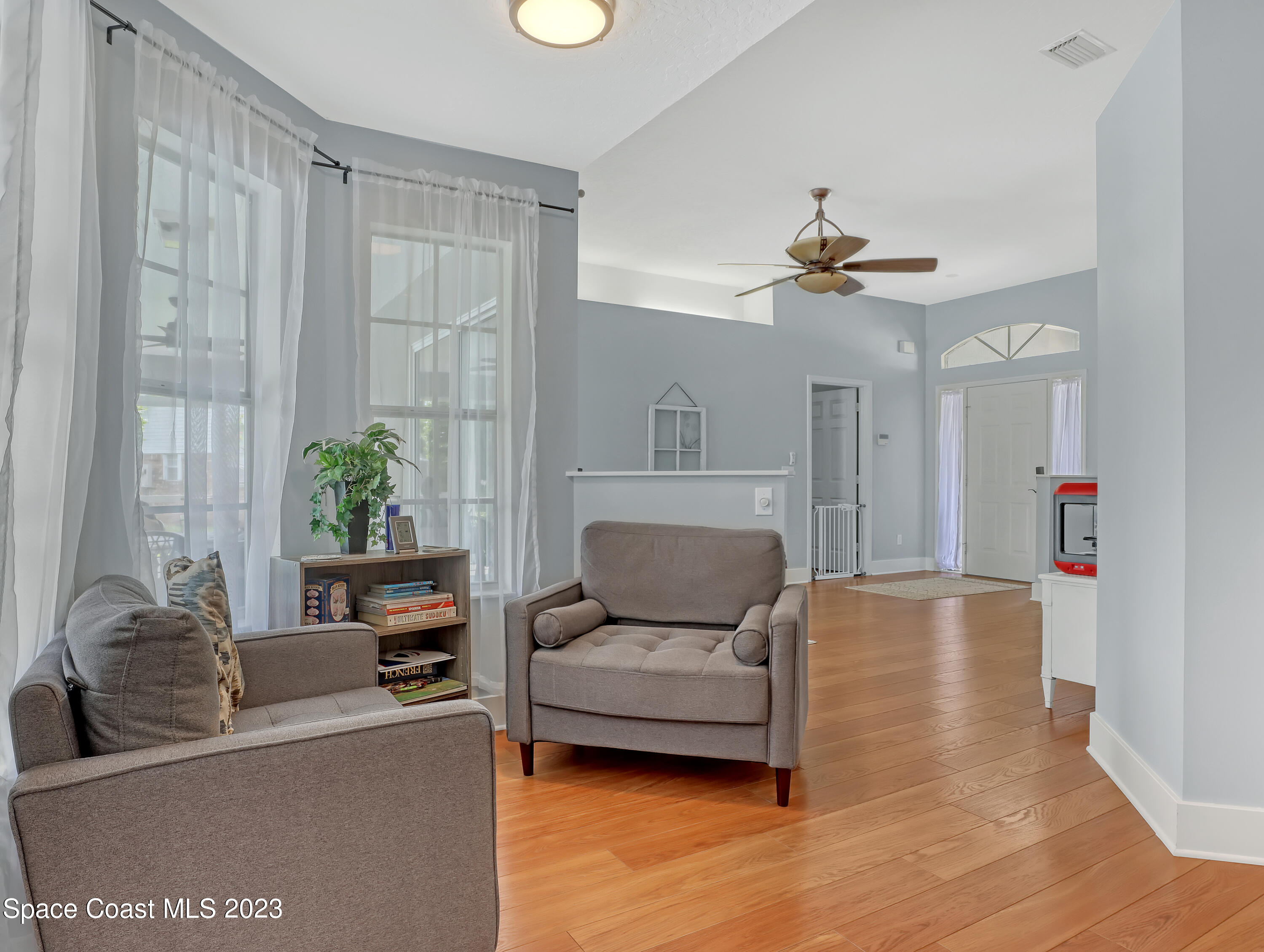 1025 Oak Tree Place Malabar, FL 32950 - Photo 9 of 33 a living room with furniture and a potted plant