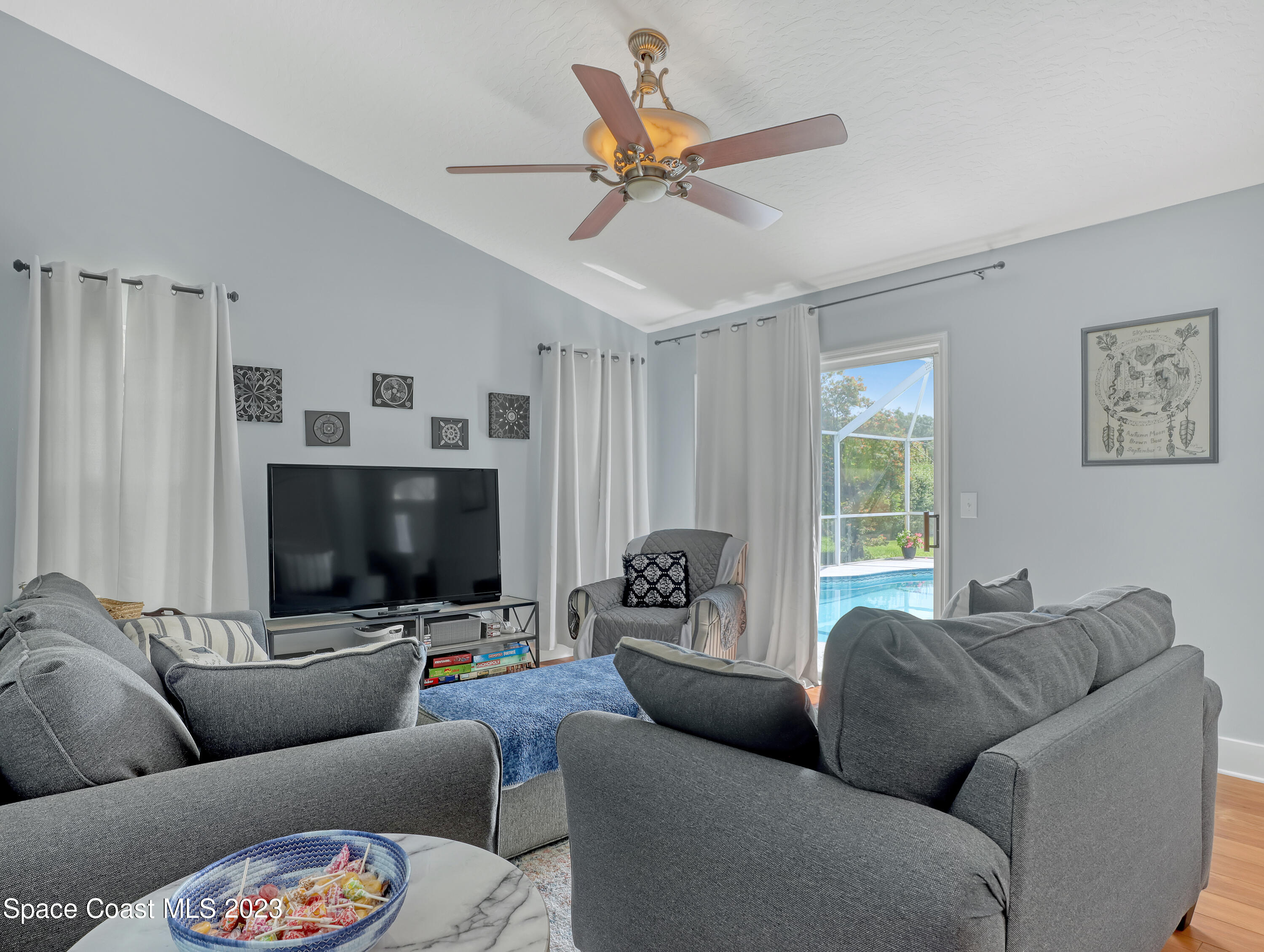 1025 Oak Tree Place Malabar, FL 32950 - Photo 10 of 33 a living room with furniture and a flat screen tv