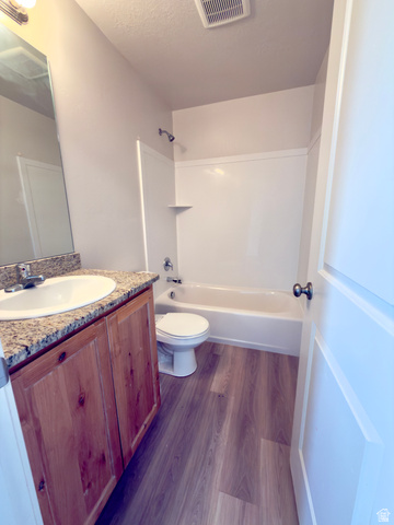 1823 South Longview Road Santaquin, UT 84655 - Photo 35 of 69 Bathroom featuring a wood-finish vanity with a granite-look countertop and integral sink