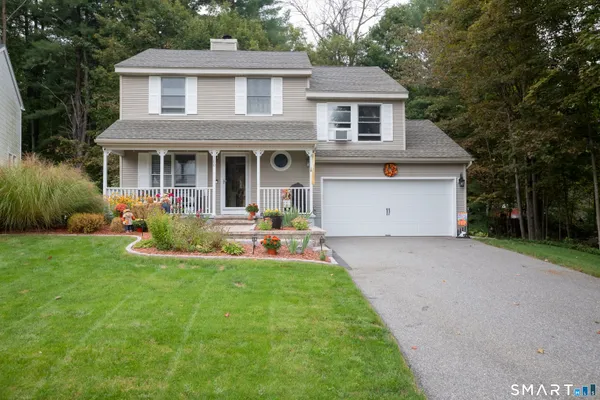 a view of a house with backyard and porch