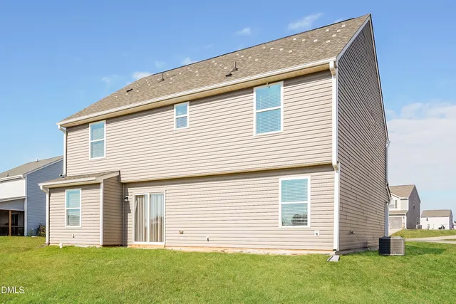 a view of a house with a backyard