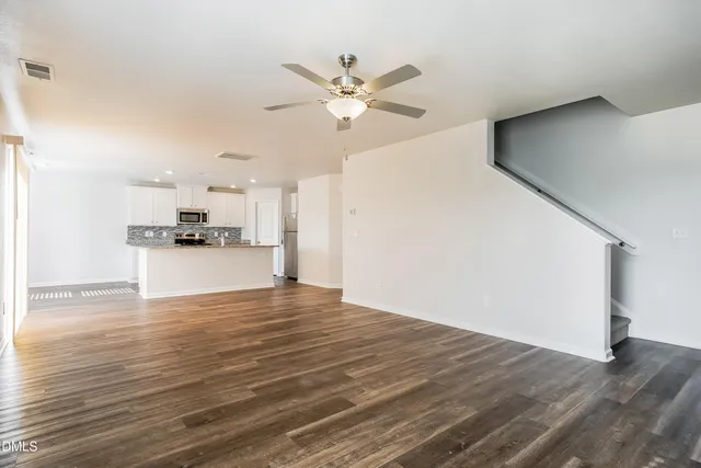 a view of a kitchen with a sink and a refrigerator