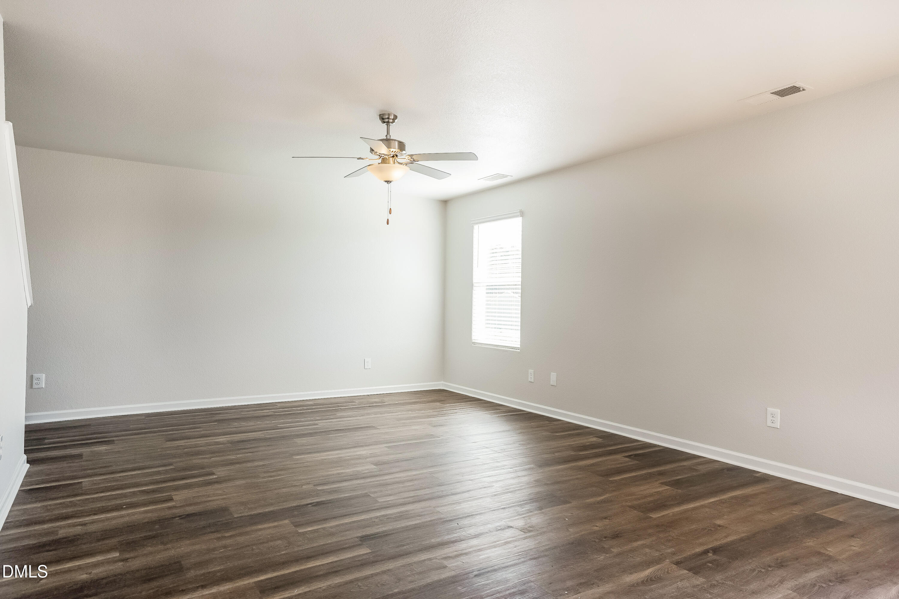 124 Lahinch Drive Fuquay-Varina, NC 27526 - Photo 3 of 17 a view of an empty room with wooden floor and a window