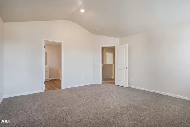 a view of an empty room and closet area